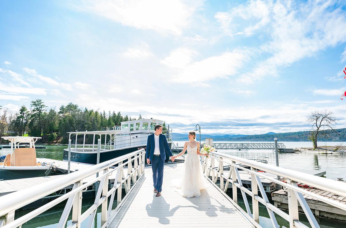 A bride and groom take wedding photos on the dock at Basin Harbor Resort. (Isora Lithgow/Basin Harbor)