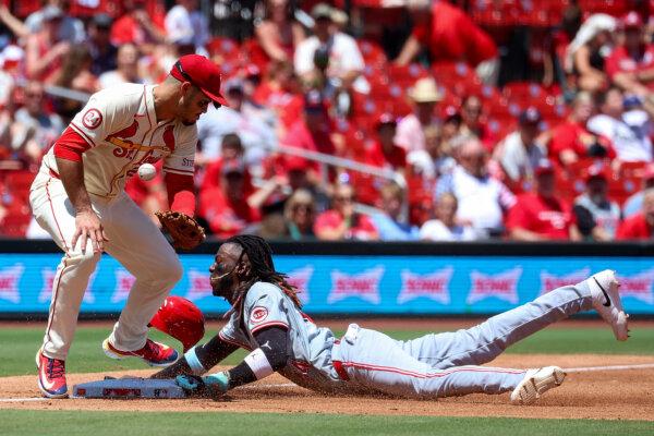 Elly De La Cruz #44 of the Cincinnati Reds steals third against Nolan Arenado #28 of the St. Louis Cardinals during the third inning at Busch Stadium in St. Louis, Missouri on June 29, 2024. (Scott Kane/Getty Images)
