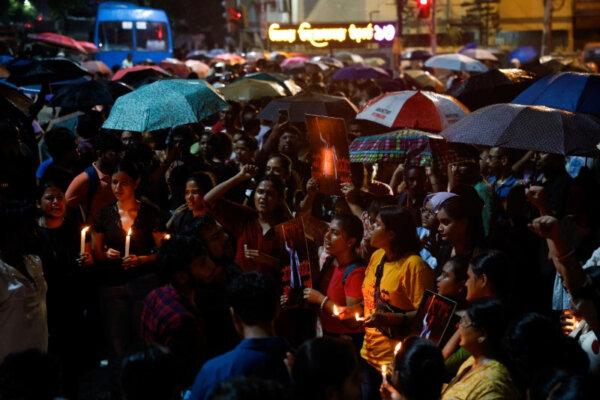People gather to participate in a candlelight vigil—for a trainee doctor who was raped and murdered at a government-run hospital—outside Jadavpur University campus in Kolkata, India, on Aug. 15, 2024. (Sahiba Chawdhary/Reuters)