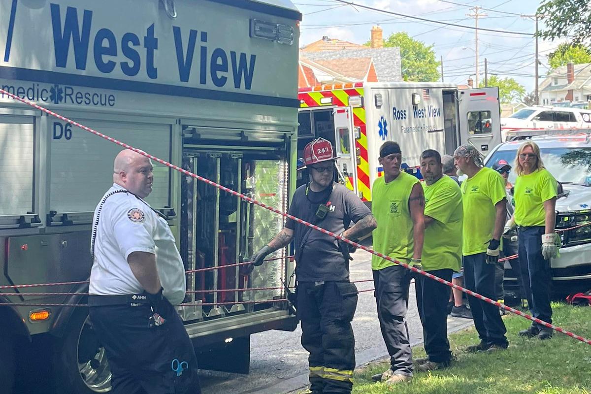 Rescuers employ ropes to raise the injured man up a 30-foot incline consisting of loose soil and trees. (Courtesy of Ross/West View EMS)