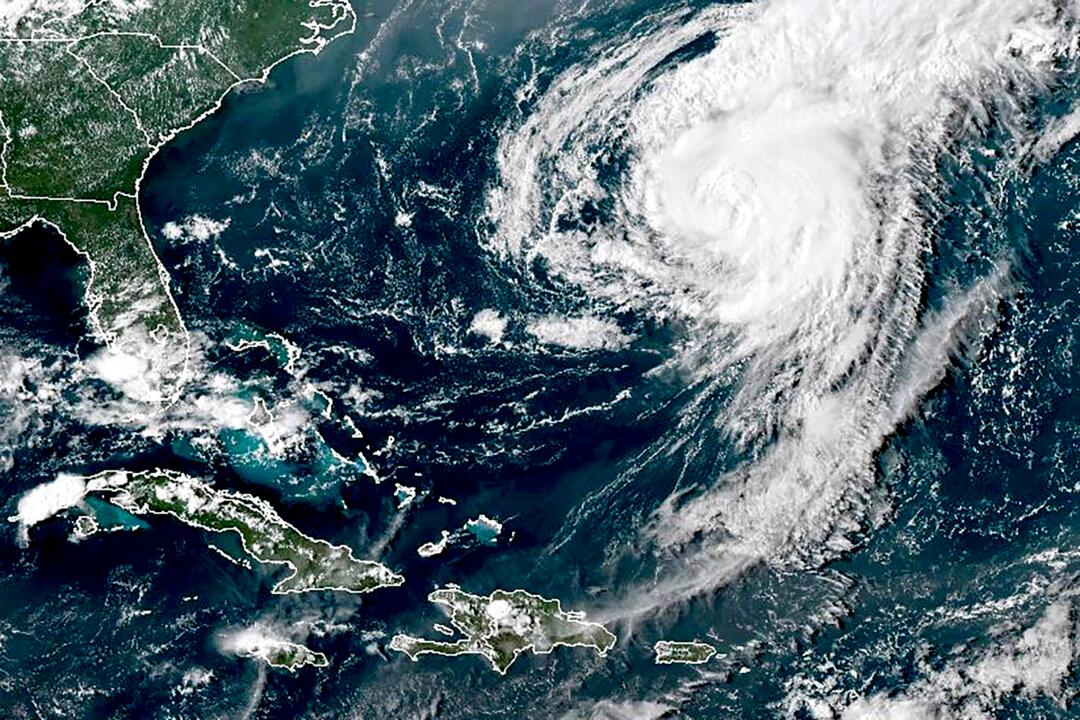 Hurricane Ernesto Weakens Into Tropical Storm as It Moves Away From Bermuda Over Open Waters