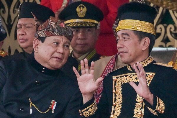 Indonesian President Joko Widodo talks to President-elect Prabowo Subianto (L) following a flag-raising ceremony marking Indonesia's 79th Independence Day at the presidential palace in the future capital Nusantara, in Sepaku, Penajam Paser Utara, East Kalimantan, on Aug. 17, 2024. (BAY ISMOYO/AFP via Getty Images)