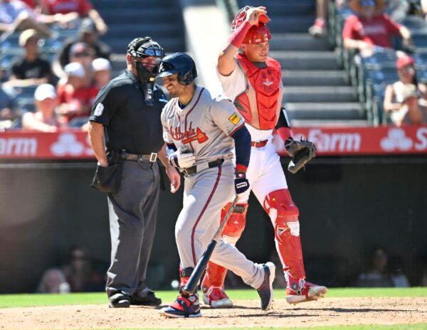 Ramón Laureano (18) of the Atlanta Braves winces after he was hit by a pitch as Logan O'Hoppe (14) of the Los Angeles Angels walks to toward the mound in the eighth inning in Anaheim, Calif., on August 18, 2024. (John McCoy/Getty Images)