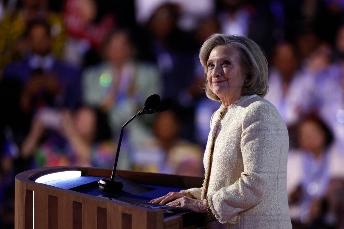 Former Secretary of State Hillary Clinton looks on as she is applauded after arriving on stage to speak on the first day of the Democratic National Convention (DNC) at the United Center in Chicago on Aug. 19, 2024. (Kamil Krzaczynski/AFP via Getty Images)