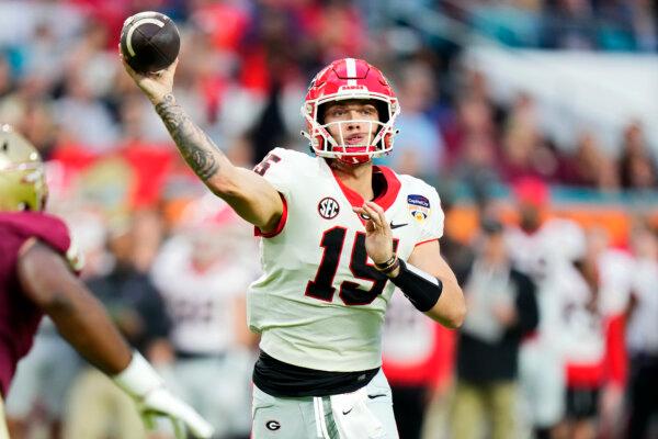 Carson Beck #15 of the Georgia Bulldogs throws a pass in the second quarter against the Florida State Seminoles during the Capital One Orange Bowl at Hard Rock Stadium in Miami Gardens, Fl., on Dec. 30, 2023. (Rich Storry/Getty Images)