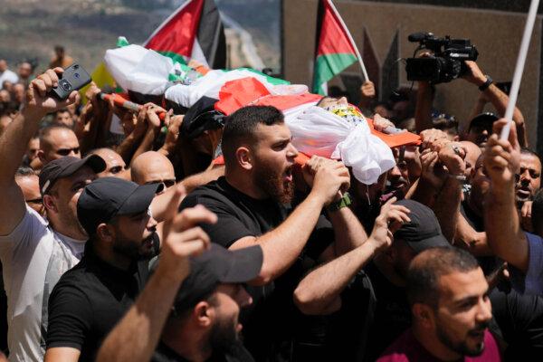 Mourners carry the body of Palestinian Rasheed Mahmoud Sadah, 23, during his funeral in the West Bank village of Jit, near Nablus, on Aug. 16, 2024. (Nasser Nasser/AP Photo)