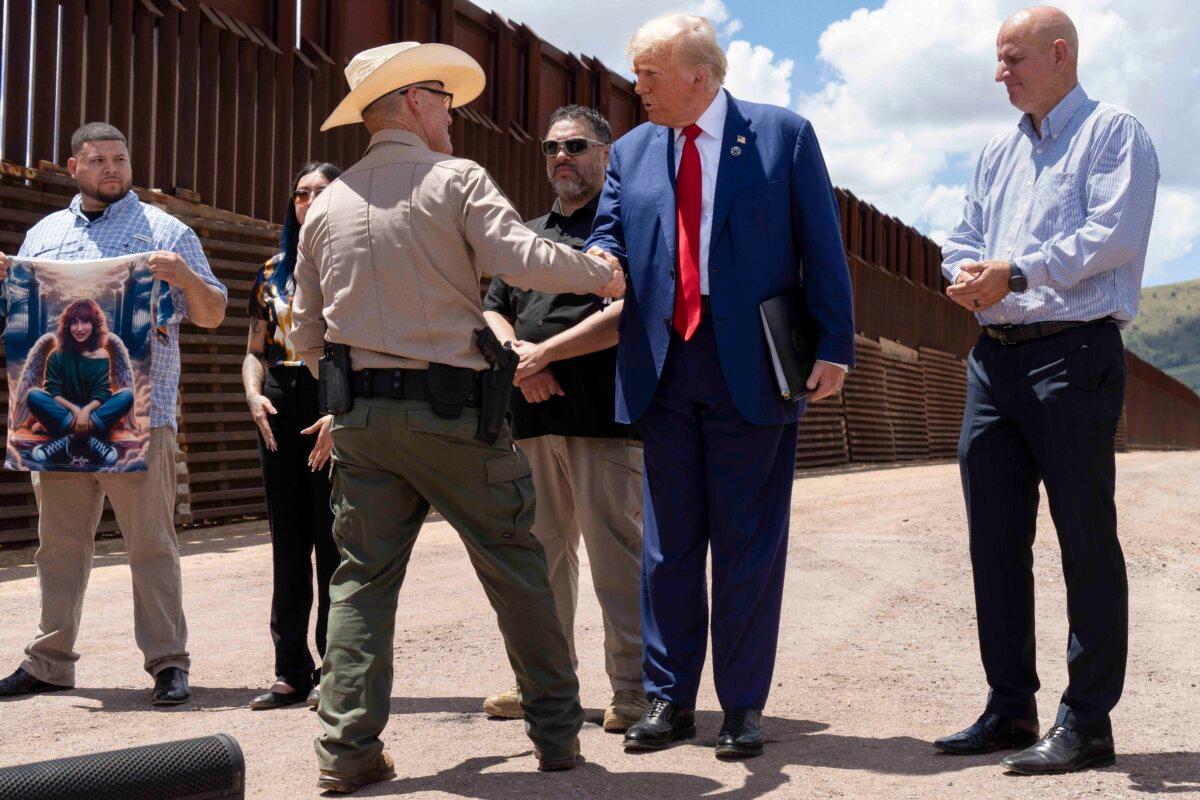 Cochise County Sheriff Mark Dannels shakes hands with former President Donald Trump at the U.S.-Mexico border fence south of Sierra Vista, Arizona, on Aug. 22, 2024. (Rebecca Noble/Getty Images)