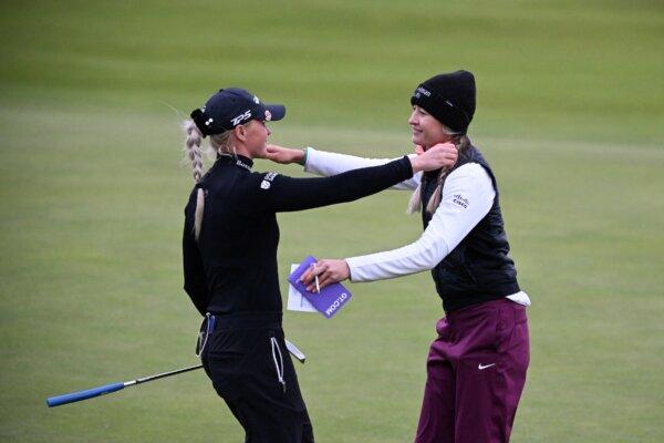England's Charley Hull (L) and US' Nelly Korda hug each other at the end of the opening day of the 2024 Women's British Open Golf Championship, on the Old Course in St Andrews, Scotland, on Aug. 22, 2024. (Andy Buchanan/AFP/Getty Images)