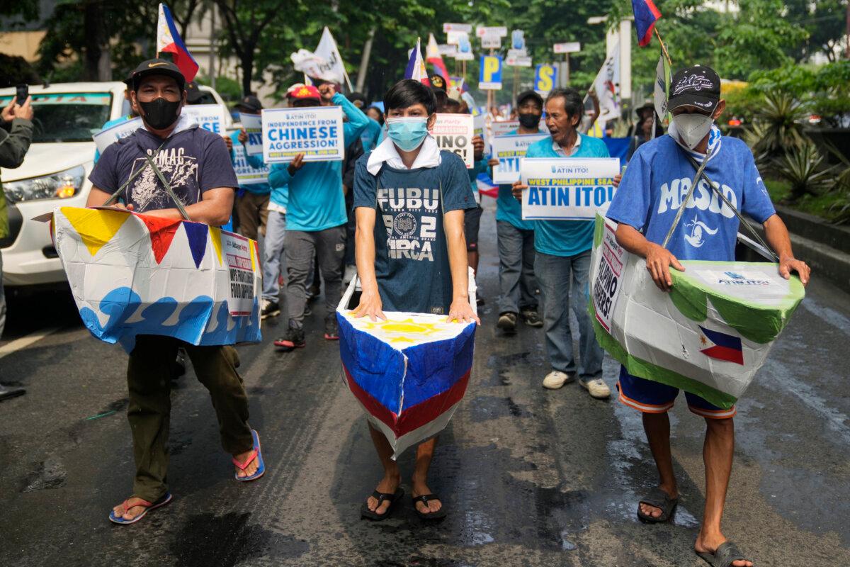 Filipino fishermen and activists wear boat costumes to protest against alleged Chinese aggression at the disputed South China Sea as they stage a rally in front of the Chinese consulate ahead of Independence Day in Makati, Philippines, on June 11, 2024. (Aaron Favila/AP Photo)