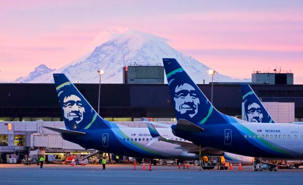 Alaska Airlines planes with Mount Rainier in the background during sunrise at Seattle-Tacoma International Airport on March 1, 2021. (Ted S. Warren/AP Photo)