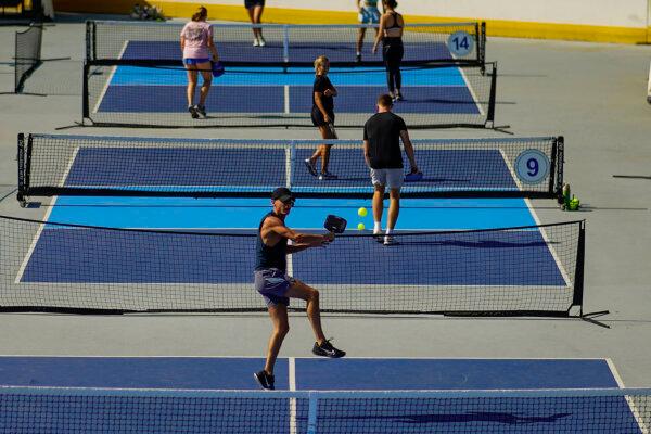 A man jumps to return the ball as people practice pickleball on the courts of CityPickle at Central Park's Wollman Rink, in New York on Aug. 24, 2024. (Eduardo Munoz Alvarez/AP Photo)