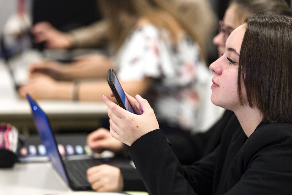 High school students use smartphones and tablet computers at the vocational school in Bischwiller, eastern France, on Sept. 26, 2017. (Patrick Hertzog/AFP via Getty Images)