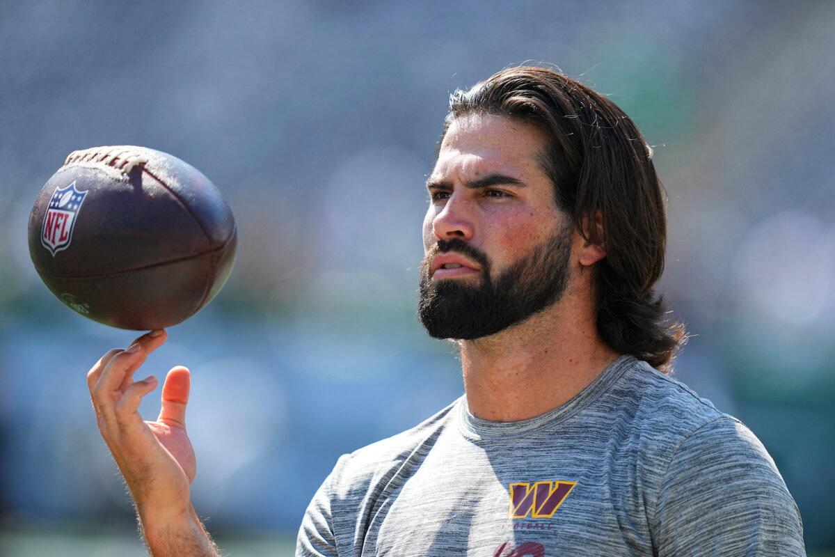 Sam Hartman, #11 of the Washington Commanders, spins a football on his finger before the preseason game against the New York Jets at MetLife Stadium in East Rutherford, N.J. on Aug. 10, 2024. (Mitchell Leff/Getty Images)