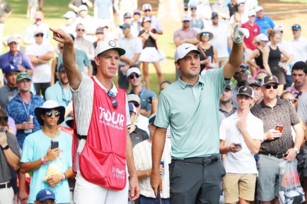 Scottie Scheffler of the United States talks with his caddie Ted Scott on the seventh hole during the third round of the TOUR Championship at East Lake Golf Club in Atlanta on Aug. 27, 2022. (Kevin C. Cox/Getty Images)