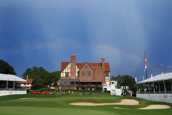 A rainbow is seen over the clubhouse and 18th green during a suspension of play in the third round of the TOUR Championship at East Lake Golf Club in Atlanta on Aug. 26, 2023. (Mike Ehrmann/Getty Images)