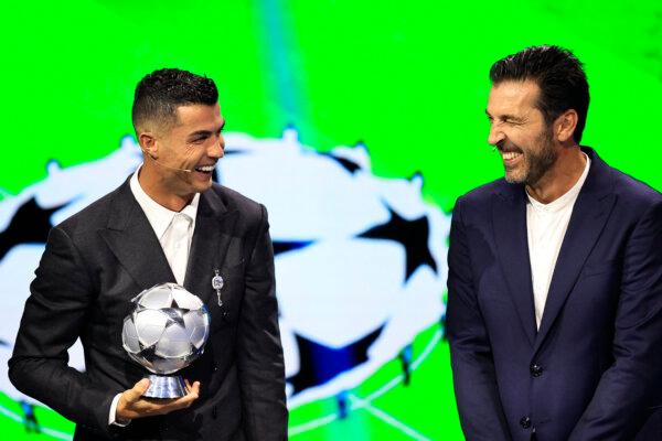 Cristiano Ronaldo, who was awarded the All-Time Goalscorer Award in the UEFA Champions League (L), and Italy's former goalkeeper Gigi Buffon, who was awarded the 2024 UEFA President's Award, are on stage during the ceremony of the draw for the group stage of the 2024–25 UEFA Champions League football tournament, at the Grimaldi Forum in Monaco on Aug. 29, 2024. (Valery Hache/AFP via Getty Images)
