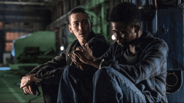 Dennis (Dylan Arnold, L), the son of the bad father, comforts Antoine (Christopher Ammanuel), the son of the good father, during the Rodney King riots, in "1992." (Lionsgate)