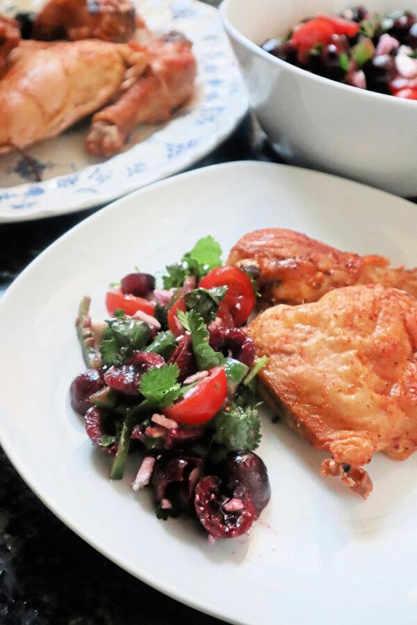 A salad of sweet cherries paired with grapes, cherry tomatoes and jalapeno adds a seasonal zing to a platter of roast chicken. (Gretchen McKay/Pittsburgh Post-Gazette/TNS)