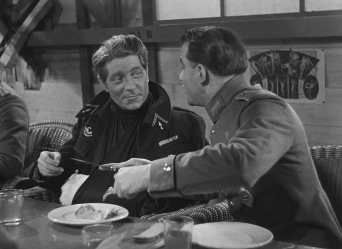 Lt. Maréchal (Jean Gabin, L) enjoys the food parcel items that Rosenthal (Marcel Dalio) shares with the prisoners, in “The Grand Illusion.” (Réalisation d'Art Cinématographique)