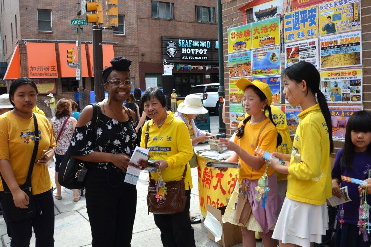 Krystal Pearson (2nd left), a holter technician, in Philadelphia Chinatown on Aug. 31, 2024. (Frank Liang/The Epoch Times)
