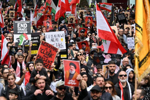 Hundreds of demonstrators hold flags and pictures of Hassan Nasrallah, the late leader of the Lebanese terrorist group Hezbollah at a protest rally in the central business district of Sydney on Sept. 29, 2024. (Saeed Khan/AFP via Getty Images)