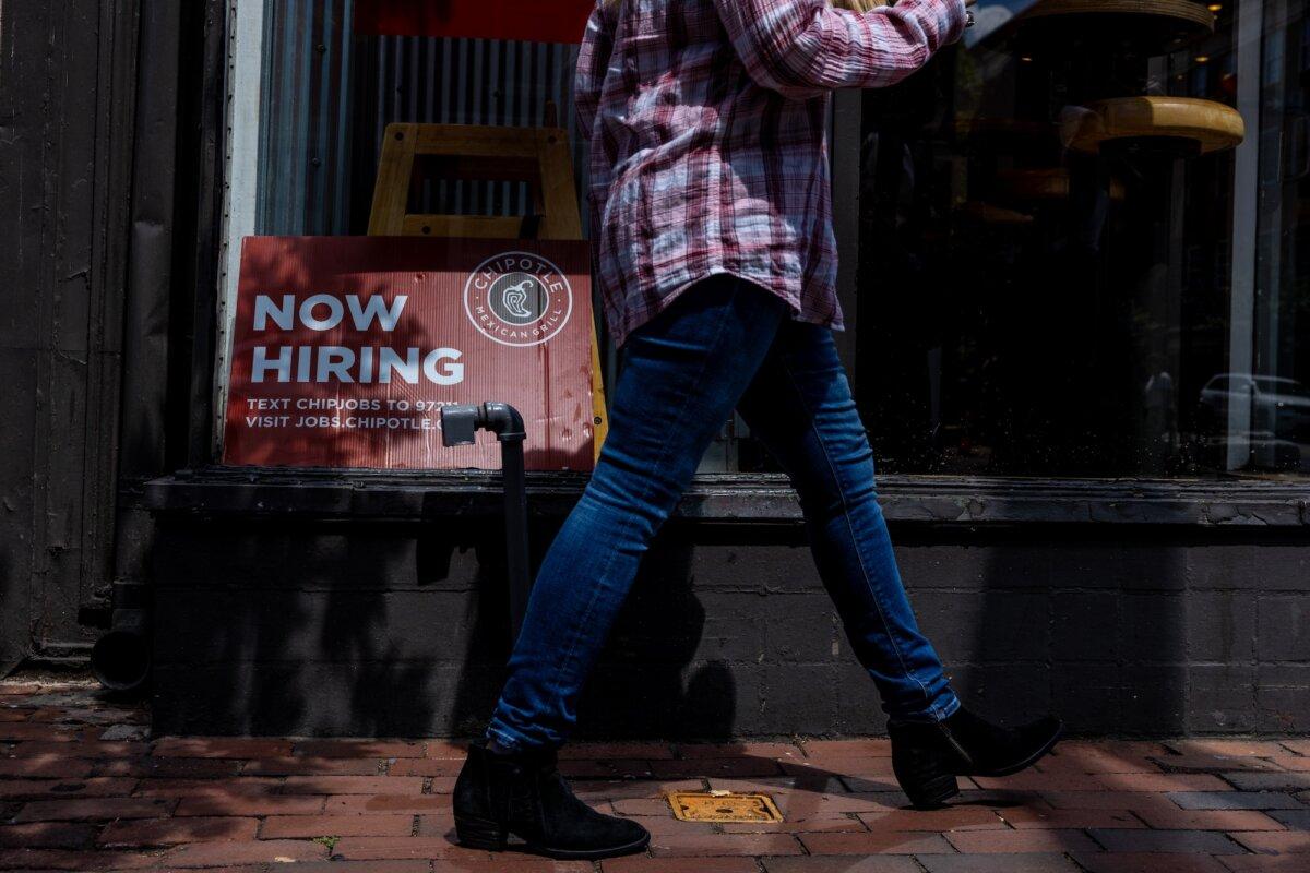 A hiring sign is displayed in the window of a restaurant in Alexandria, Va., on Aug. 22, 2024. (Anna Rose Layden/Getty Images)