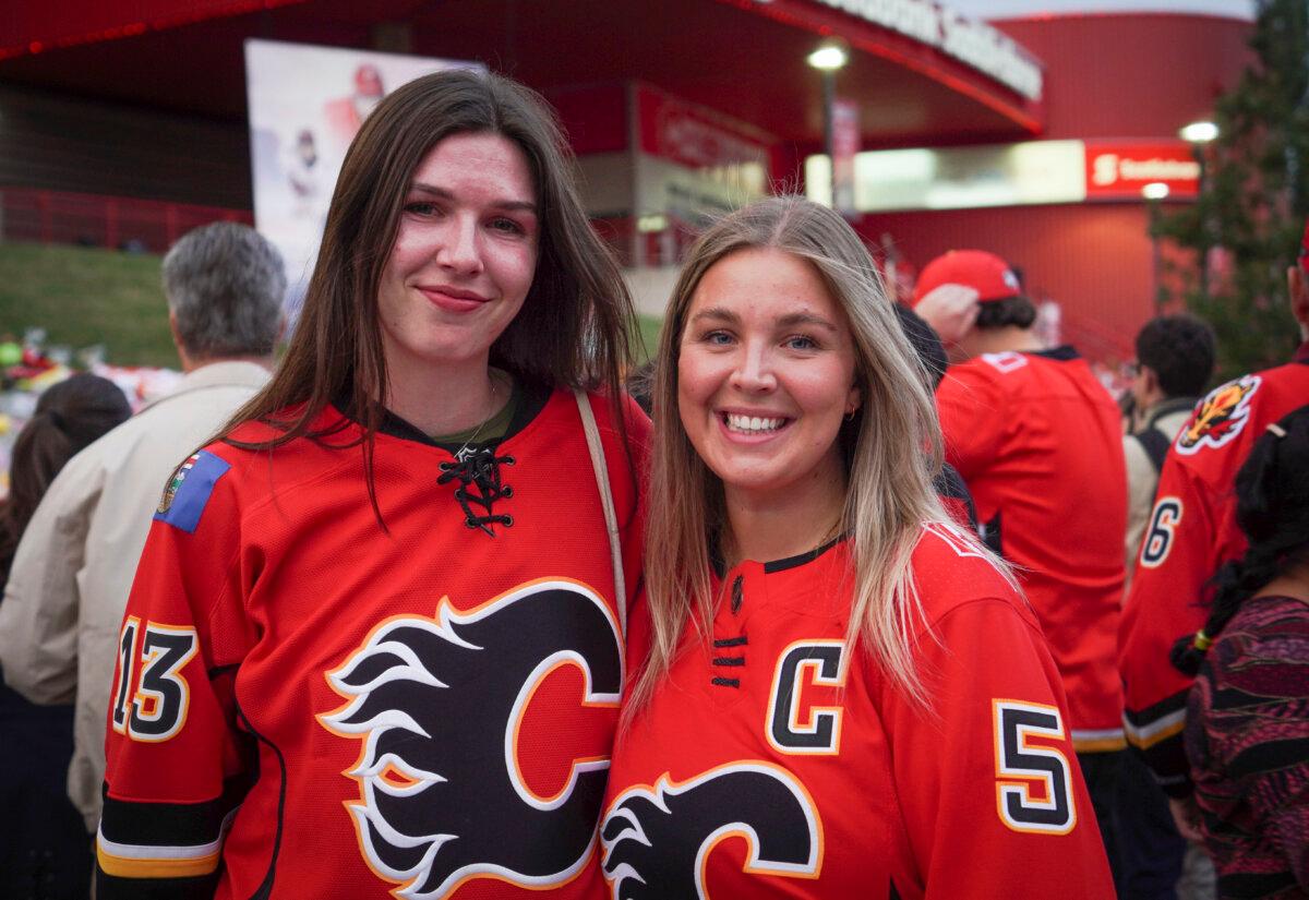 Audrey Buston (L) and her friend Ali Cassels at the candlelight vigil honouring former Calgary Flames star Johnny Gaudreau and his brother Matthew outside the Scotiabank Saddledome in Calgary on Sept. 4, 2024. (Carolina Avendano/The Epoch Times)