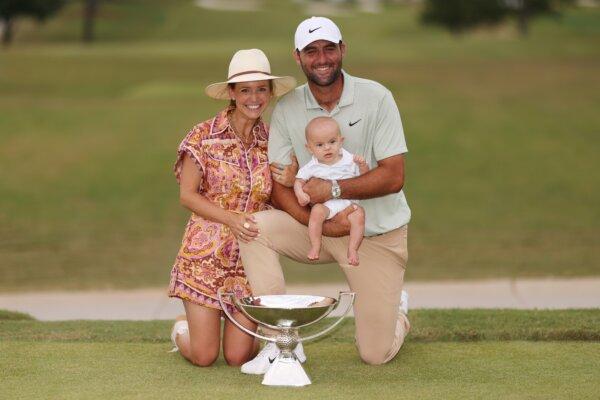Scottie Scheffler of the United States celebrates with his wife Meredith, son Bennett and the trophy after winning the FedExCup and the Tour Championship at East Lake Golf Club in Atlanta on Sept. 1. (Mike Mulholland/Getty Images)
