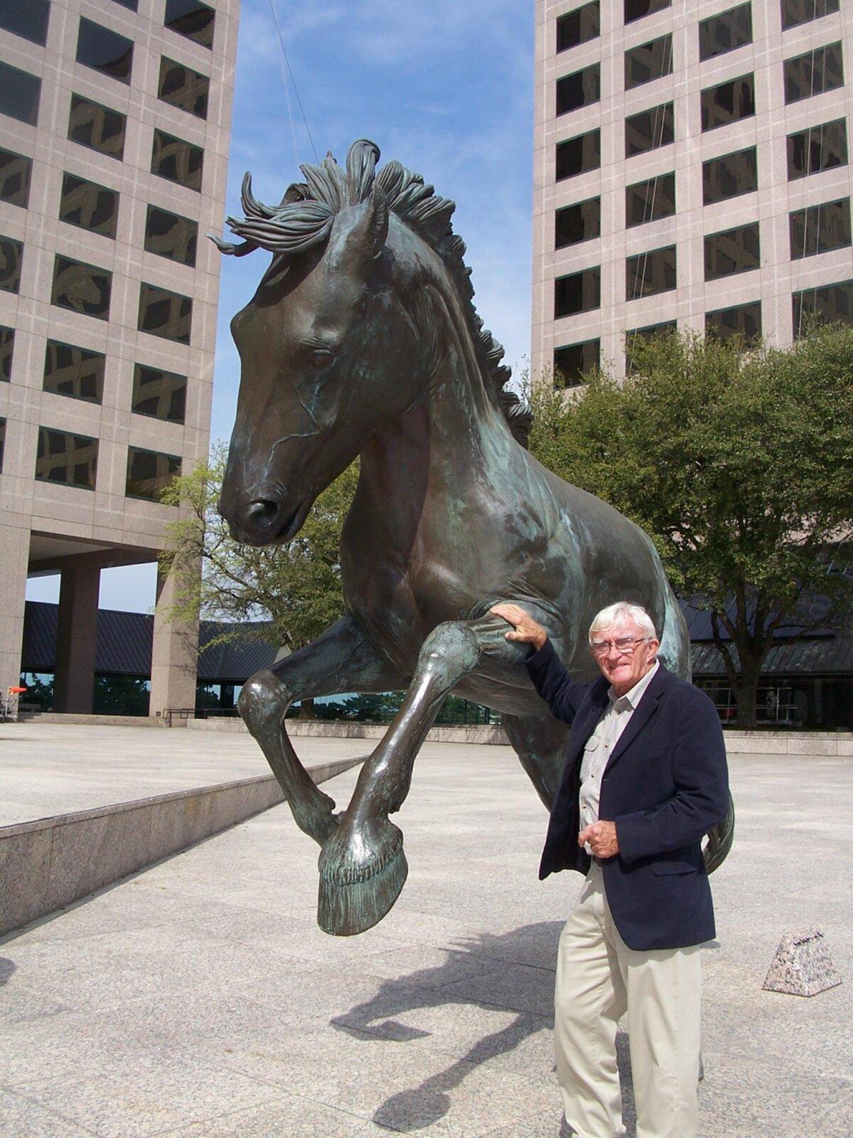 African wildlife artist Robert Glen stands next to a bronze stallion he created for his "Mustangs of Las Colinas" sculpture, in Irving, Texas. Sept. 25 marks the 40th anniversary of the sculpture. (Courtesy of The City of Irving)