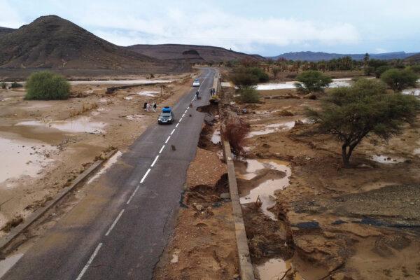 Cars drive through a road that was damaged by floods caused by heavy rainfall in Tazarine, Zagora, southern Morocco, Sunday, Sept. 8, 2024 (AP Photo)