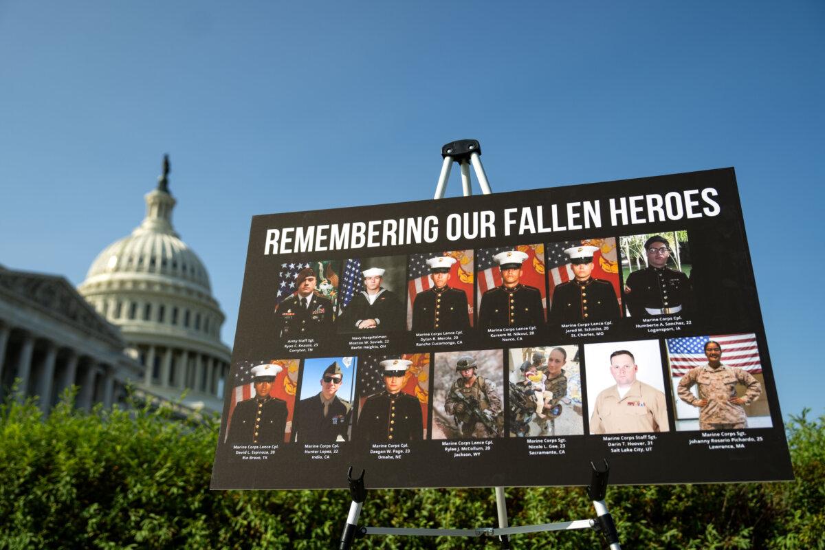 A sign in Washington displaying photos and names of the 13 service members killed in a terrorist attack at Abbey Gate outside Kabul's Hamid Karzai International Airport. Photo taken on Sept. 9, 2024. (Kent Nishimura/Getty Images)