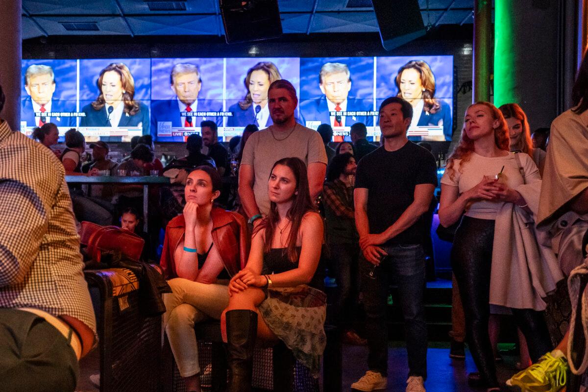 People watch the presidential debate between Democratic presidential nominee, Vice President Kamala Harris, and Republican presidential nominee, former President Donald Trump, at a watch party at the Slate bar and lounge in New York City on Sept. 10, 2024. (Samira Bouaou/The Epoch Times)