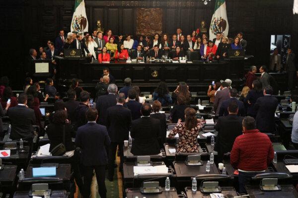 Opposition senators protest behind the executive table during a debate on judicial reforms in the Senate building in Mexico City, Mexico, September 10, 2024. (Luis Cortes/Reuters)