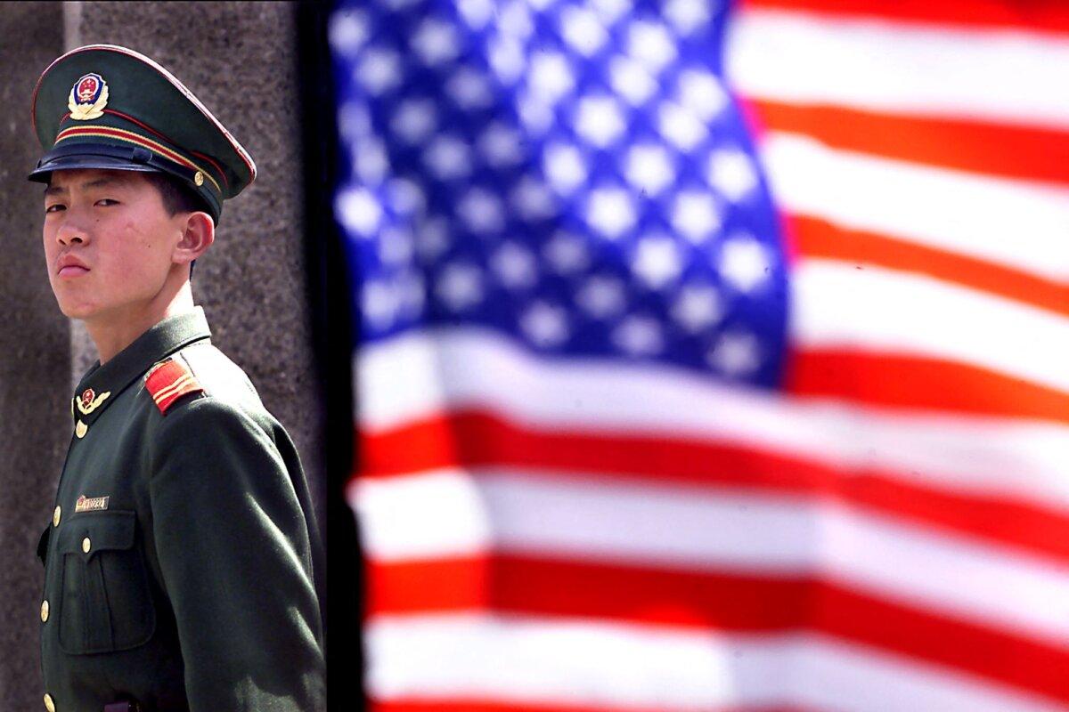 A Chinese military policeman stands guard in front of the U.S. Embassy as he and others stand guard around the compound in Beijing, on April 3, 2001. (Stephen Shaver / AFP via Getty Images)