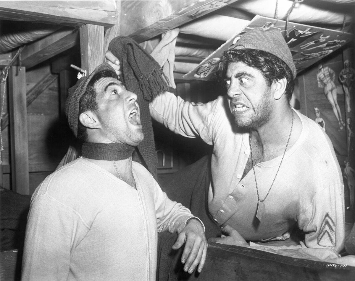 Some of the comedy antics of Sgt. Harry Shapiro (Harvey Lembeck, L) and his buddy Sgt. Stanislaus “Animal” Kuzawa (Robert Strauss), in “Stalag 17.” (Paramount Pictures)