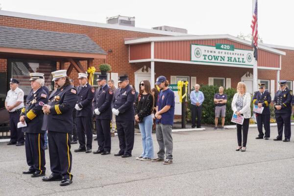 Attendees stood in a moment of silence for 9/11 victims at a memorial ceremony in the town of Deerpark, N.Y., on Sept. 11, 2024. (Cara Ding/The Epoch Times)
