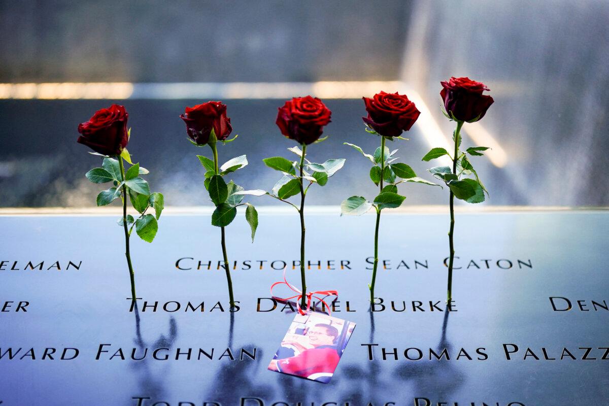 Roses are left next to the names of victims on the North Tower Memorial Pool during during the 23rd anniversary of the September 11 terror attack on the World Trade Center at Ground Zero, in New York City on Sept. 11, 2024. (Adam Gray/AFP via Getty Images)
