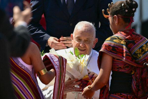 Pope Francis (C) is greeted upon his arrival at Presidente Nicolau Lobato International Airport in Dili on Sept. 9, 2024. (Tiziana Fabi/AFP via Getty Images)