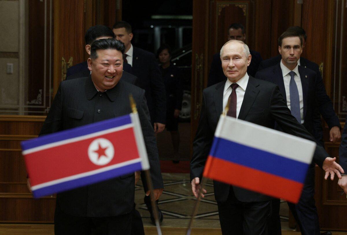 In this pool photograph distributed by Russian state news agency Sputnik, North Korean leader Kim Jong Un walks with Russian President Vladimir Putin at a welcoming ceremony upon Putin's arrival in Pyongyang on June 19, 2024. (GAVRIIL GRIGOROV/POOL/AFP via Getty Images)