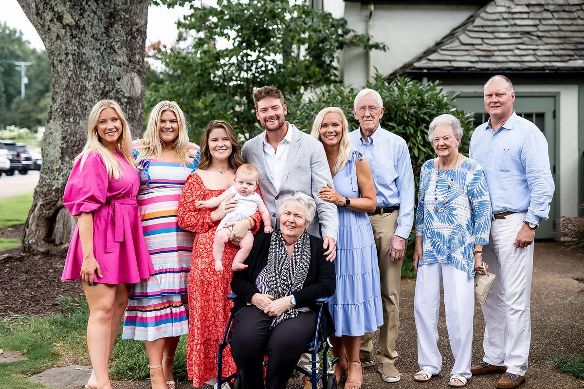 Mrs. Morgan with the whole family: (L to R) her two daughters; her daughter-in-law and son with their child; her mother (seated) and father; her mother-in-law; and her husband. (Thelen Wright Photography)