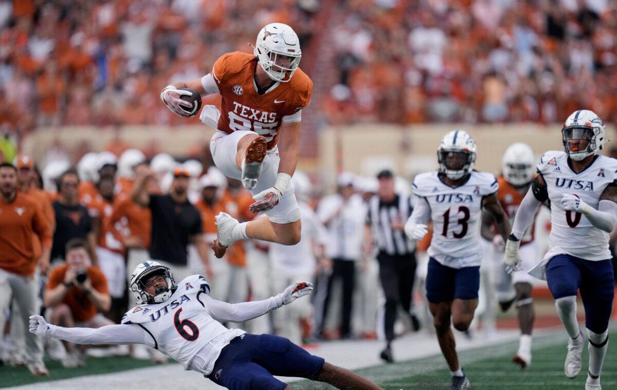 Texas tight end Gunnar Helm (85) leaps over UTSA safety Elliott Davison (6) during the first half of an NCAA game in Austin, Texas, on Sept. 14, 2024. (Eric Gay/AP Photo)