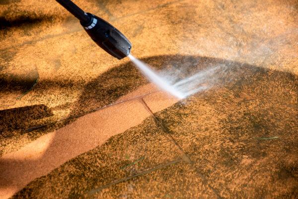 Pressure washing pathways effectively removes built-up dirt, debris, mold, algae, and stains from concrete, brick, stone, or asphalt surfaces. (Daria Nipot/Shutterstock)