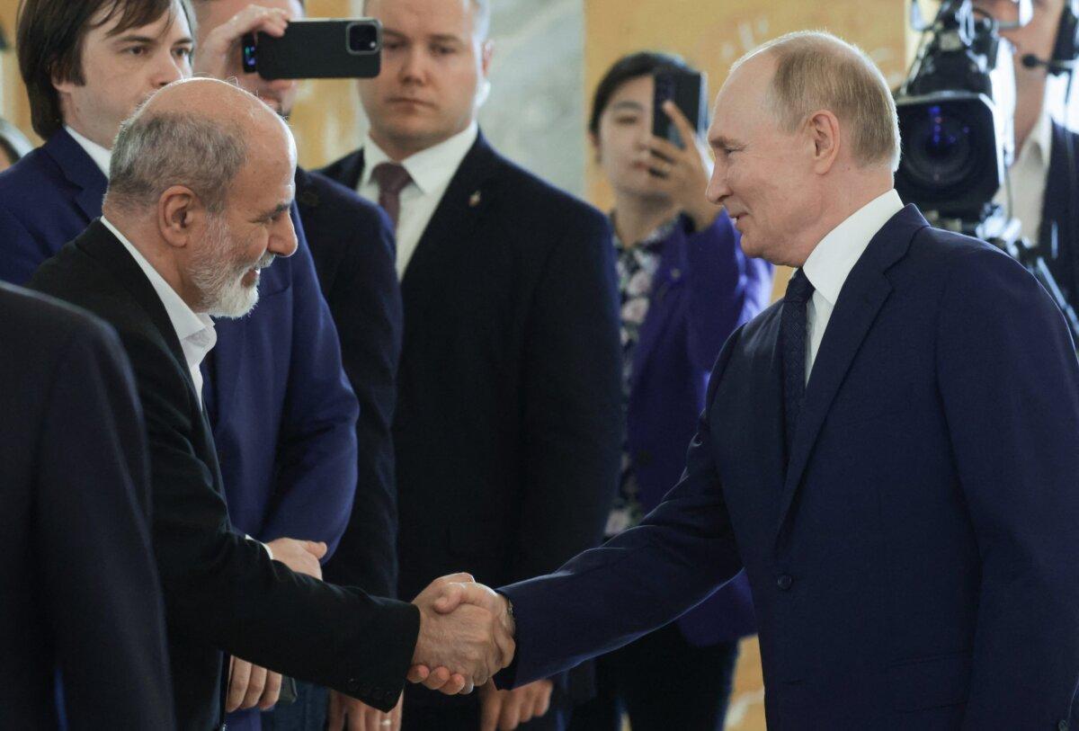 Russian President Vladimir Putin shakes hands with Ali Akbar Ahmadian, secretary of Iran's Supreme National Security Council, as he meets with BRICS high-ranking officials responsible for security matters/national security advisers in Saint Petersburg, Russia, on Sept. 12, 2024. (Vyacheslav Prokofyev/Pool/AFP via Getty Images)