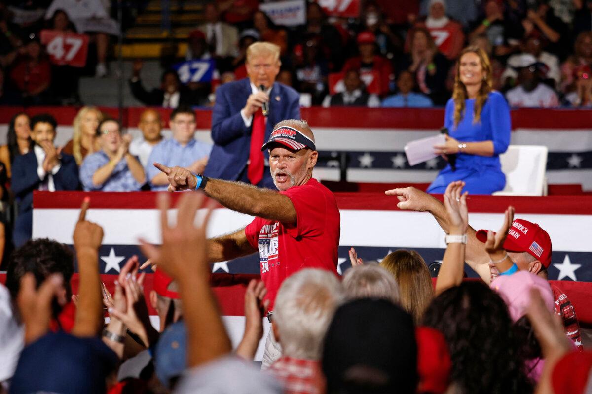 Auto Workers for Trump founder Brian Pannebecker (C) is recognized by former President and Republican presidential nominee Donald Trump during a town hall meeting moderated by Arkansas Gov. Sarah Huckabee Sanders (R) at the Dort Financial Center in Flint, Mich., on Sept. 17, 2024. (Jeff Kowalsky/AFP via Getty Images)
