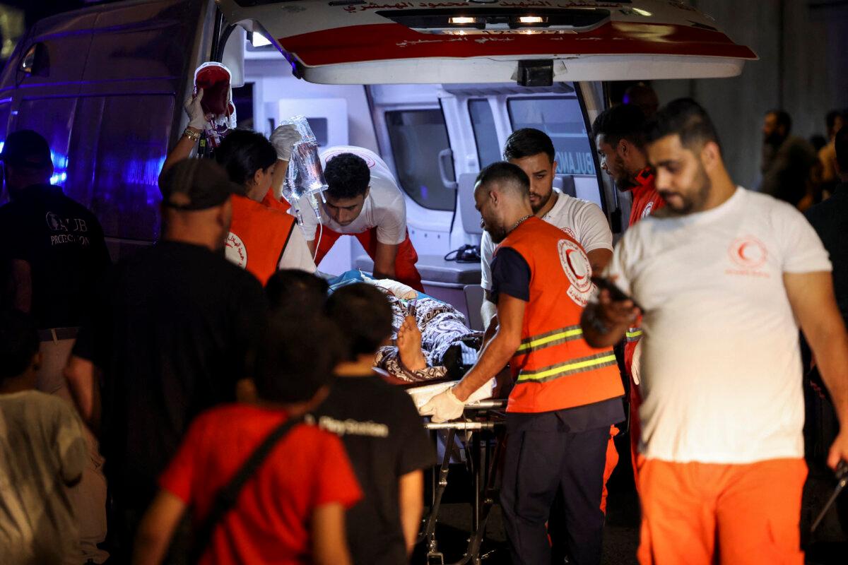 A casualty is carried on a stretcher outside American University of Beirut Medical Center as people, including Hezbollah members, were killed or wounded when the pagers they use to communicate exploded across Lebanon, according to a security source in Beirut on Sept. 17, 2024. (Mohamed Azakir/Reuters)