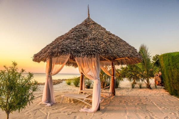 Beach lounge chairs at sunset, Zanzibar, Tanzania. (Dreamstime/TNS)