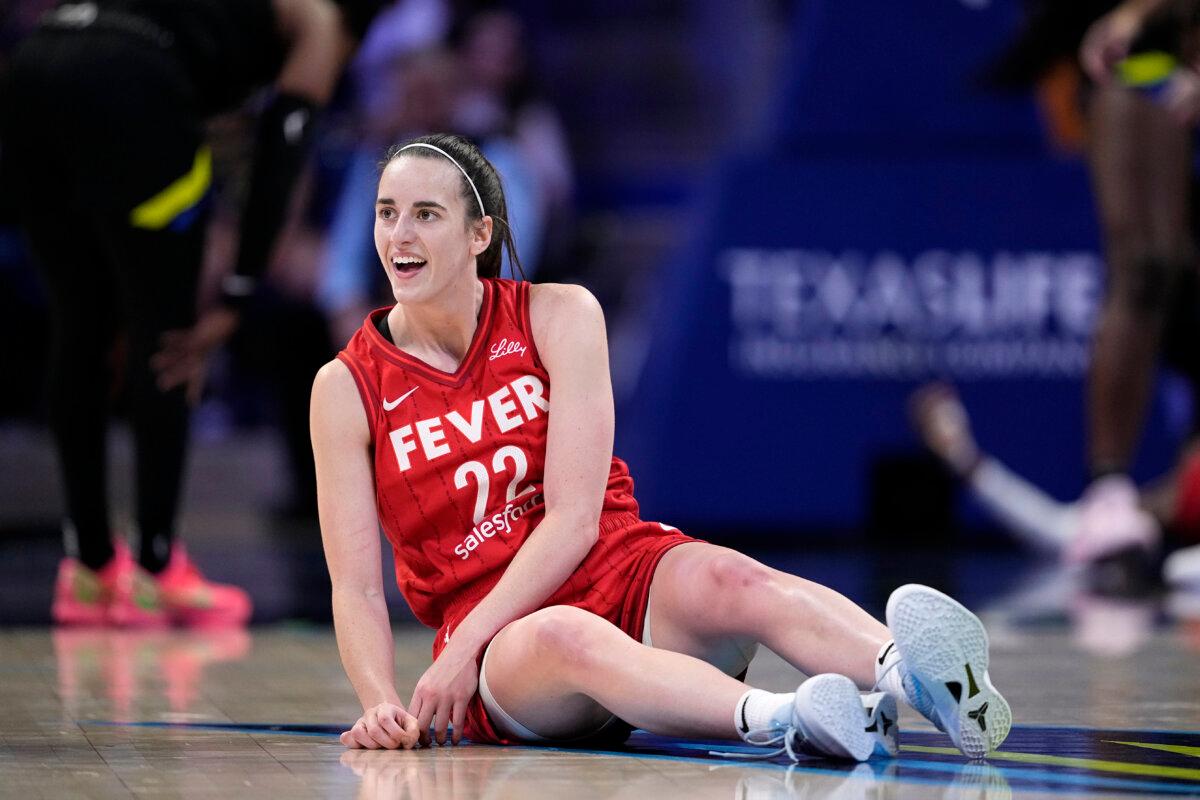 Indiana Fever guard Caitlin Clark smiles as she looks to the team bench after making a pass to the basket that lead to a score in the second half of a WNBA basketball game against the Dallas Wings in Arlington, Texas, on Sept. 1, 2024. (Tony Gutierrez/AP Photo)