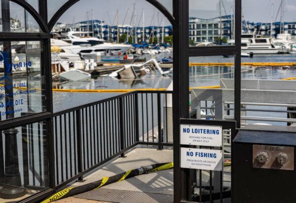 Authorities investigate a yacht that burned and sank in the harbor in Marina Del Rey, Calif., on Sept. 20, 2024. (John Fredricks/The Epoch Times)