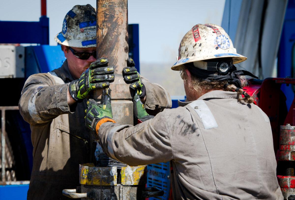 Workers change pipes at Consol Energy Horizontal Gas Drilling Rig exploring the Marcellus Shale outside the town of Waynesburg, Pa., on April 13, 2012. (Mladen Antonov /AFP via Getty Images)