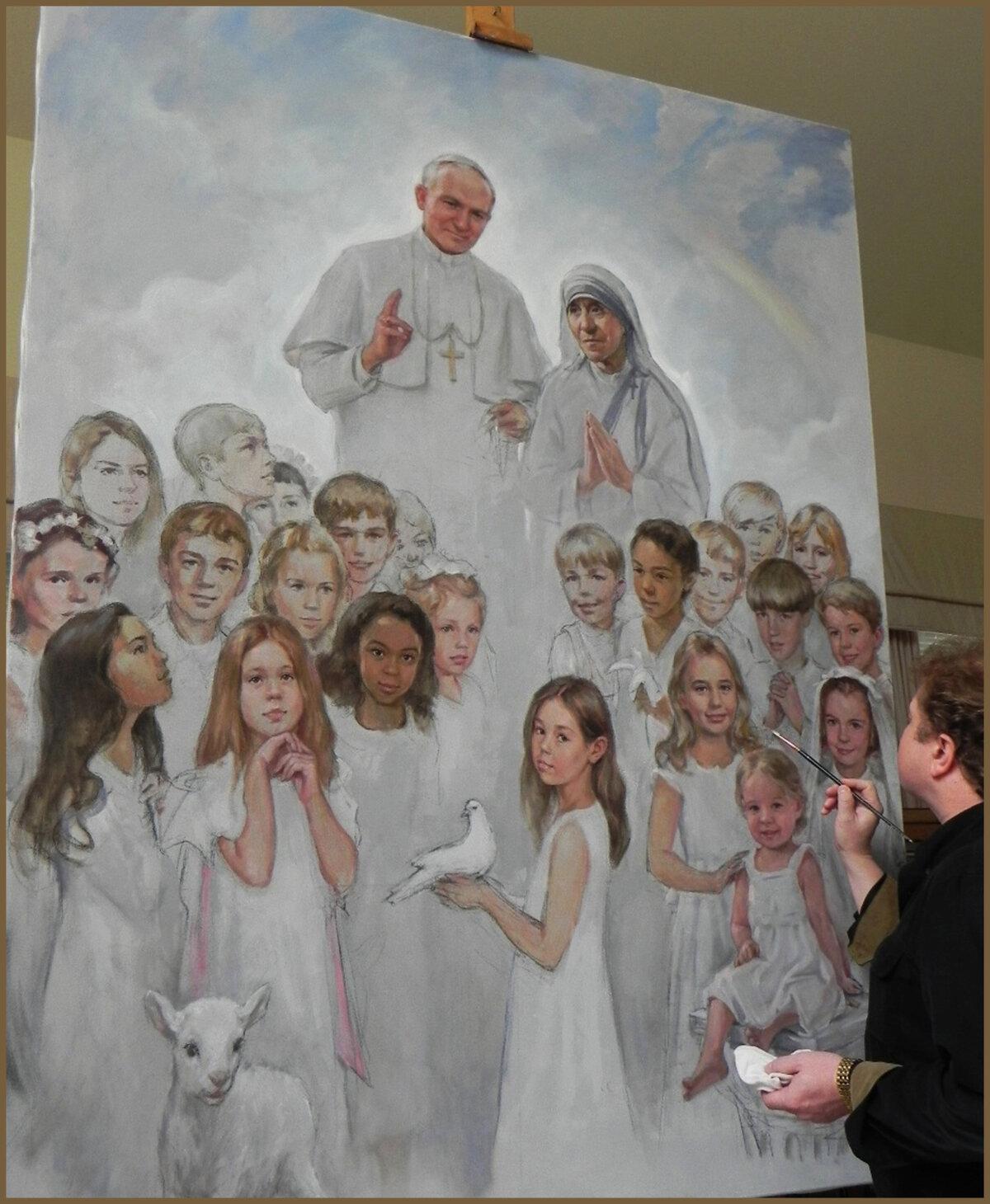 Igor Babailov creating his 8-by-6-foot oil painting “CREDO” in 2016. Several families commissioned the painting, which includes their children and grandchildren with saints John Paul II and Mother Teresa. The painting is displayed in the Saint John Paul II National Shrine in Washington. (Courtesy of Igor Babailov)